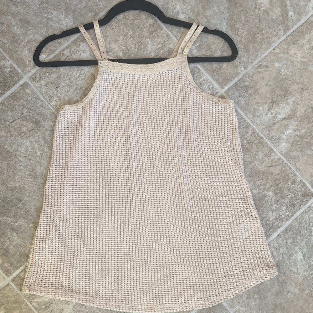 Cream colored tank with gold accent. Never worn.